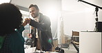 Film, fist bump and success with director speaking to person on set for advertising satisfaction. Behind the scenes, finished and motivation with videographer man talking to actress for done shoot