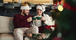 Happy couple, cheers or sofa with coffee for christmas celebration or december holiday in home. Man, woman and kiss on cheek with love, cup or mug for bonding, festive or christian tradition in house