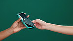 Machine, credit card and hands of people in studio for payment, transaction or POS with shopping. Purchase, banking and and customer with debit for retail, ecommerce or sale by green background.