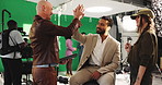 High five, tablet and thumbs up with director on set for advertising or videography success. Behind the scenes, green screen and motivation with man speaking to talent in studio for film direction