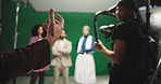 Hands, director and action on film set with people, advice and cameraman for recording at shoot. Actor, production staff and cinematography with creativity, instructions and tips  at movie studio