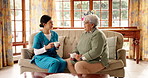 Nurse, woman and conversation with tea cup on sofa for counselling session in retirement home. Caregiver, elderly person and talk with coffee, listen and story with assisted living services in house