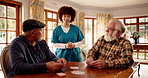 Nurse, senior men and playing cards with talk, smile and contest with cognitive challenge in retirement. Elderly friends, people and caregiver with game, competition and smile discussion for bridge