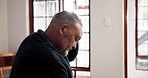 Anxiety, depression and regret with senior man in retirement home for memories or nostalgia. Alone, relax and thinking with unhappy old person in bedroom of apartment for contemplation or frustration