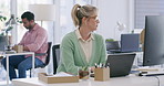 Mature creative businesswoman typing an email on a laptop while multitasking and reading on a computer in the office. Serious and focused professional responding to clients and searching the internet
