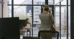 Rear view of a young businesswoman late for an interview with an annoyed looking employer in a modern office