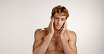 Skincare, beauty and face of man in studio for hydration, self care and facial treatment. Dermatology, cosmetics and glow with person and touch on white background for shine, aesthetic and grooming 