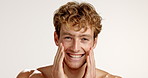 Skincare, touch and face of man in studio for hydration, self care beauty and facial treatment. Dermatology, cosmetics and glow with person on white background for shine, aesthetic and grooming 