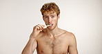 Bamboo toothbrush, face or man in studio white background for smile or hygiene. Portrait, eco friendly or model with space, morning routine or paste for brushing teeth, dental cleaning or oral health