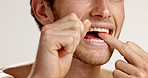 Dental floss, mouth or man in studio for cleaning germs, bacteria and oral hygiene on white background. Person, dentistry and male model with string for tooth to prevent cavity, decay or gum disease
