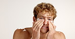 Face, happy man and eye mask for skincare, collagen or dermatology on white studio background. Apply, model and facial patches for hygiene, glow and hydration treatment with cosmetics for beauty