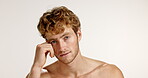 Beauty, smile and touch with face of man in studio for skincare, self care and cosmetics. Dermatology, grooming and aesthetic with male person on white background for cosmetology, shine and glow