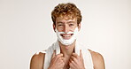 Face, shaving and smile with man on studio background for grooming, hair removal or hygiene routine. Foam, skincare and towel with satisfied person getting ready in bathroom for morning wellness