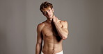 Face, skincare and man in studio, shirtless and beauty with dermatology on gray bakground. Portrait, person and model with confidence, cosmetics and muscular with grooming, body care and hygiene