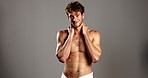 Studio, man and face with smile for skincare, dermatology and confidence with happiness in towel. Mockup space, male person or model in portrait for cosmetics, smooth with wellness or gray background