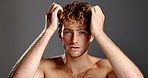Man, face and hair care in studio, shirtless and confidence with results, color and volume by background. Person, model and touch with hairstyle, highlights and transformation for cosmetics in Spain