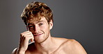 Studio, man and face with dermatology for skincare, touching and confidence with smile for beard. Mockup space, male person and model in portrait for cosmetics, smooth and hygiene in gray background