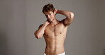 Studio, man and face with body for skincare, dermatology and happiness with confidence in towel. Mockup space, male person and model in portrait for cosmetics, glowing and wellness in gray background