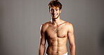 Happy, man and face in studio for skincare, dermatology and confidence with glowing in towel. Mockup space, male person and model in portrait for cosmetics, smooth body or wellness in gray background