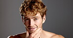 Studio, man and face with hygiene for skincare, dermatology and confidence with smile for beard. Mockup space, male person and model in portrait for cosmetics, smooth and wellness in gray background