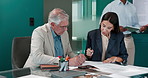 Boardroom, colleagues and people with paperwork, financial planning and data analysis or investment. Serious, mature man and collaboration with woman, documents and discussion for business growth