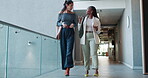 Business, women or walking in office with discussion for story ideas, article planning or news update. Journalism, low angle and employees at publishing agency with sharing info and meeting briefing