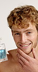 Face, man and perfume in studio for self care, essence or smile for hygiene. Portrait, cologne and confident model with cosmetics product for beauty, aftershave or clean smell on white background