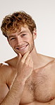 Face, grooming and smile of shirtless man in studio for masculine health, hygiene or wellness. Aesthetic, beauty and skincare with body of happy or muscular model on white background for dermatology