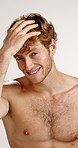 Face, hair and smile of shirtless man in studio for masculine health, hygiene or wellness. Aesthetic, body and haircare with happy or muscular model on white background for organic shampoo treatment