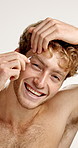 Man, beauty and tweezers for eye brow in studio with closeup, face and grooming by white background. Person, model and tools for facial hair removal, self care and routine with portrait in Germany