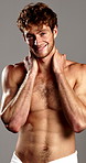 Confident, skincare and man with towel in studio for wellness, cleaning or hygiene routine. Dermatology, beauty and portrait of person with muscles for cosmetics, washing or shower on gray background