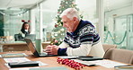 Mature businessman, laptop and typing at Christmas in office with review, smile or finance results. Person, happy and feedback for profit, revenue or excited at xmas with computer at insurance agency