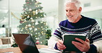 Man, tablet and laptop at Christmas in office with smile for notification, results or good news. Person, happy and tech at xmas with computer for profit, revenue increase or bonus at financial agency