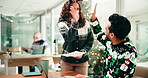 Christmas, success and people in office, high five and celebration for research on website and team. Happy, colleagues and gesture for achievement in business, festive season and smile for laptop