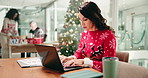 Christmas, woman and typing on laptop in office for client email, festive campaign or data analysis. Marketing specialist, xmas and employee with documents for social media engagement and KPI report