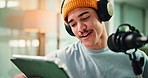 Broadcast, headphones and man on mic with tablet for reading news, live streaming or announcement. Radio, presenter or talking in studio for public relations, on air update or social media engagement