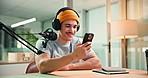 Man, phone and smile with mic for podcast with typing, scroll or reading chat for live stream. Person, influencer and happy with smartphone, app or social network for content creation at media agency