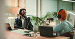Podcast, interview and men with mic in studio, content creation or live stream of discussion on web. Happy, podcaster and talking to guest with headphones, online and conversation with influencer