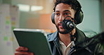 Tablet, podcast and man with mic in studio for hosting, broadcast or interview with online questions. Content creation, live stream and person on digital tech for audio, radio presenter and recording
