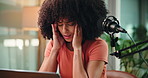Woman, headache and stress with laptop for podcast, exhausted and deadline for recording at studio. African person, migraine and pain with computer, burnout and fatigue at creative media company