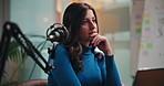 Woman, thinking and laptop with mic for podcast, content creation or review at media company. Person, presenter or host for radio show in studio with decision, story or editing script for broadcast