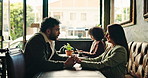 Love, talking and couple holding hands at restaurant for bonding together, flirt and connection. Romance, people and happy at coffee shop with conversation, support and affection on anniversary date