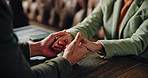 Love, romance and couple holding hands at restaurant for bonding together, trust and connection. Relationship, people or affection at coffee shop with touch, support or admiration on anniversary date