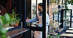 Greeting, restaurant and waiter with customer at door for friendly service, opening and hospitality. Diner, cafe and man with woman at entrance for small business, welcome and coffee shop startup