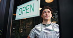 Small business, entrance and man in cafe, open sign and waiter with friendly service. Person, thinking and employee with billboard, retail storefront and restaurant with customer welcome or start day