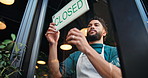Closed, door and waiter with sign at cafe for public notice, no service and end of trading hours. Manager, below and man with board message at storefront for customer information and advertisement