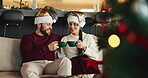 Christmas, coffee and toast with couple on sofa in living room of home together for celebration. Cheers, love and smile with happy people in apartment for festive bonding, holiday or vacation
