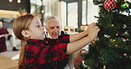 Grandpa, child or tree with ornament for christmas celebration or christian tradition in house. Happy grandparent, kid or granddaughter with bauble or hanging decorations for december holiday in home