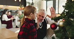 Happy grandpa, child and christmas with high five for tree decor or celebration together in house. Grandparent, kid or granddaughter with smile, bauble or hanging decorations for december holiday