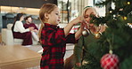 Christmas, decoration or tree with with grandchild and granny in living room of home together. Activity, bonding or festive celebration with senior woman and girl in apartment for December holidays